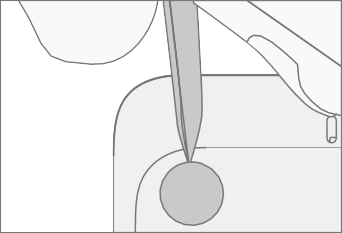 Screenshot that shows a nylon spudger being used to pry up a foot to expose the screw wells under the device.