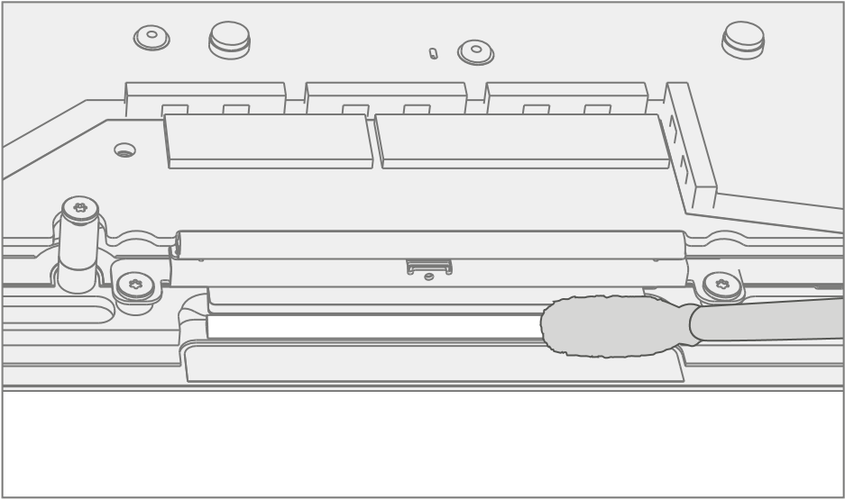 An illustration showing how to clean adhesive tape remnants and residue from the keyboard assembly using 70% or greater isopropyl alcohol