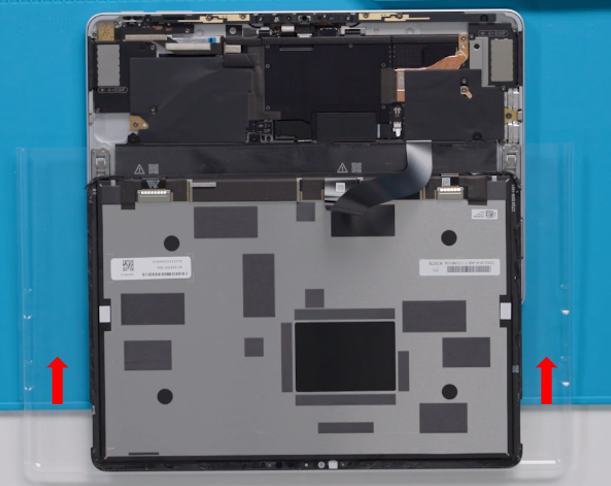 Screenshot that shows the display module separated from the enclosure with adhesive peeled away.