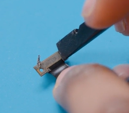 Photo that shows a close-up of a technician preparing the front camera area for removal.